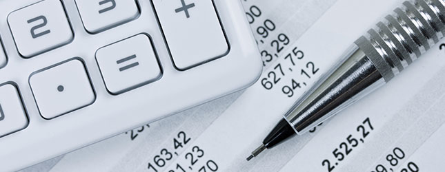 Accounting tools and services including a calculator, pen and information.